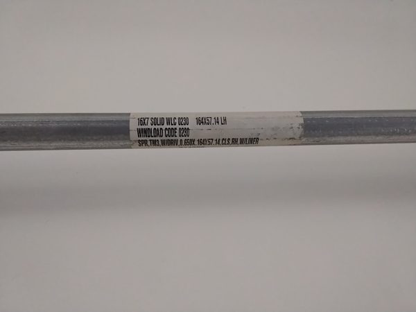 Factory label on the spring tube of a Wayne Dalton TorqueMaster door on a Chesapeake job, printed 16X7 SOLID WLC 0230, 164X57.14 LH, WINDLOAD CODE 0230