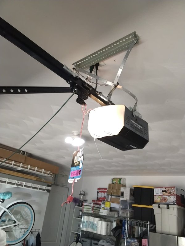 New Chamberlain belt-drive garage door opener mounted on the ceiling rail after an opener repair in Cape Charles on the Virginia Eastern Shore, August 2026