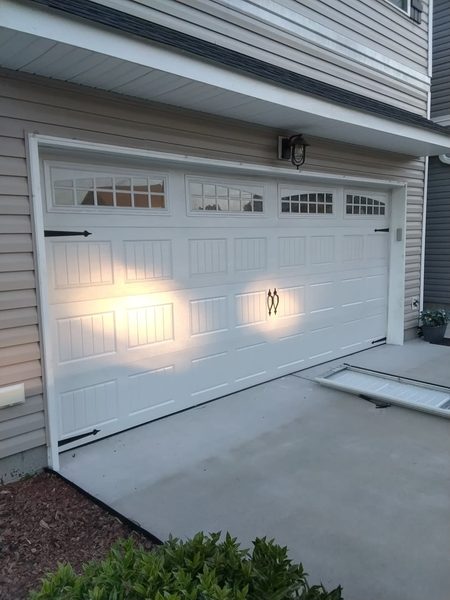 Garage door repair in Portsmouth VA: the same 16x7 door closed and level after two new sections, September 16, 2026