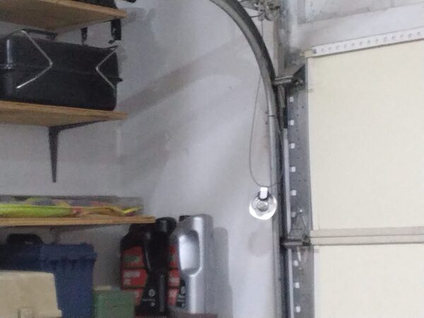 Broken extension spring wiring hanging loose in a Cradock, Portsmouth garage before repair